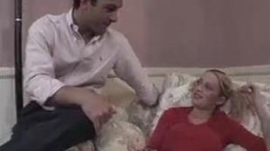 Young blonde with pigtails rides one cock while sucking another